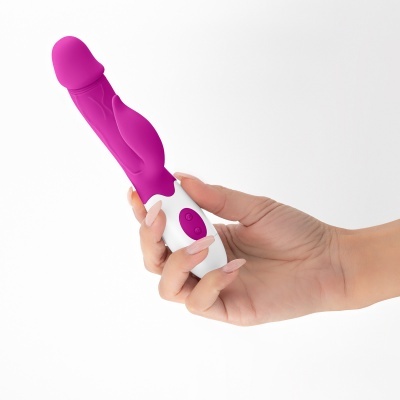 Vibrador rosa e branco segurado por mão humana