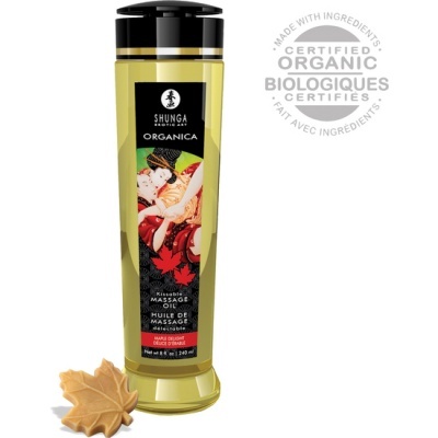 Frasco de óleo de massagens Shunga Organica amarelo com rótulo preto e ilustração artística, selo Certified Organic e folhas de bordo