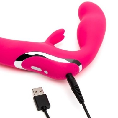 Vibrador rosa com cabo USB para carregamento numa superfície branca