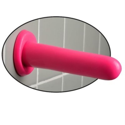 Produto adulto cor-de-rosa fixado numa parede com azulejos