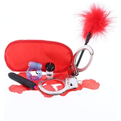 Kit de acessórios sexuais com algemas, venda, pluma, anel e pequenos dispositivos em fundo branco