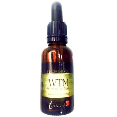 Frasco âmbar com conta-gotas e rótulo verde e preto de produto chamado WTVM Woman To Man