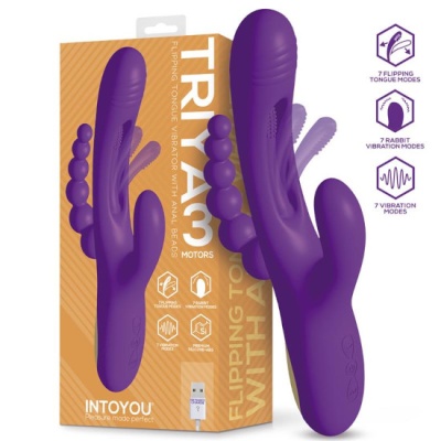 Vibrador roxo de silicone com duas partes, em frente a uma caixa com texto e ícones