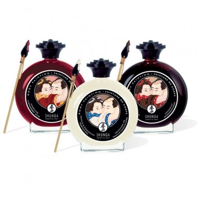 Três frascos redondos coloridos com tampas pretas e etiquetas ilustradas, acompanhados por pequenos pincéis.