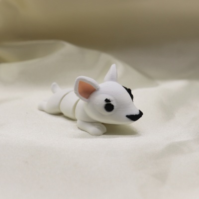 Figura de cão branco com manchas pretas sobre tecido branco