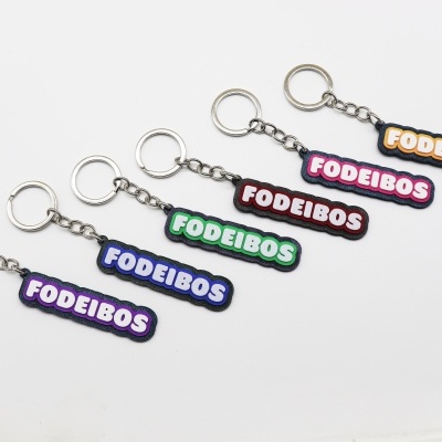 Seis porta-chaves coloridos com texto FODEIBOS