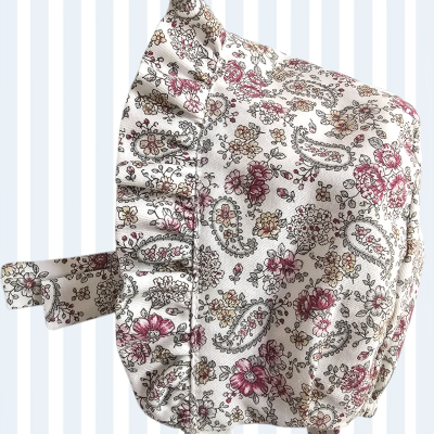 Touca estampada floral com babados e fita sobre fundo listrado azul e branco