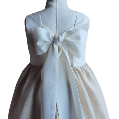 vestido infantil branco e bege com laço grande nas costas numa manequim