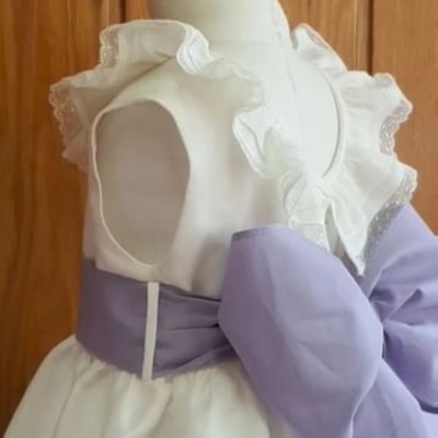 Vestido branco de criança com folhos e laço lilás
