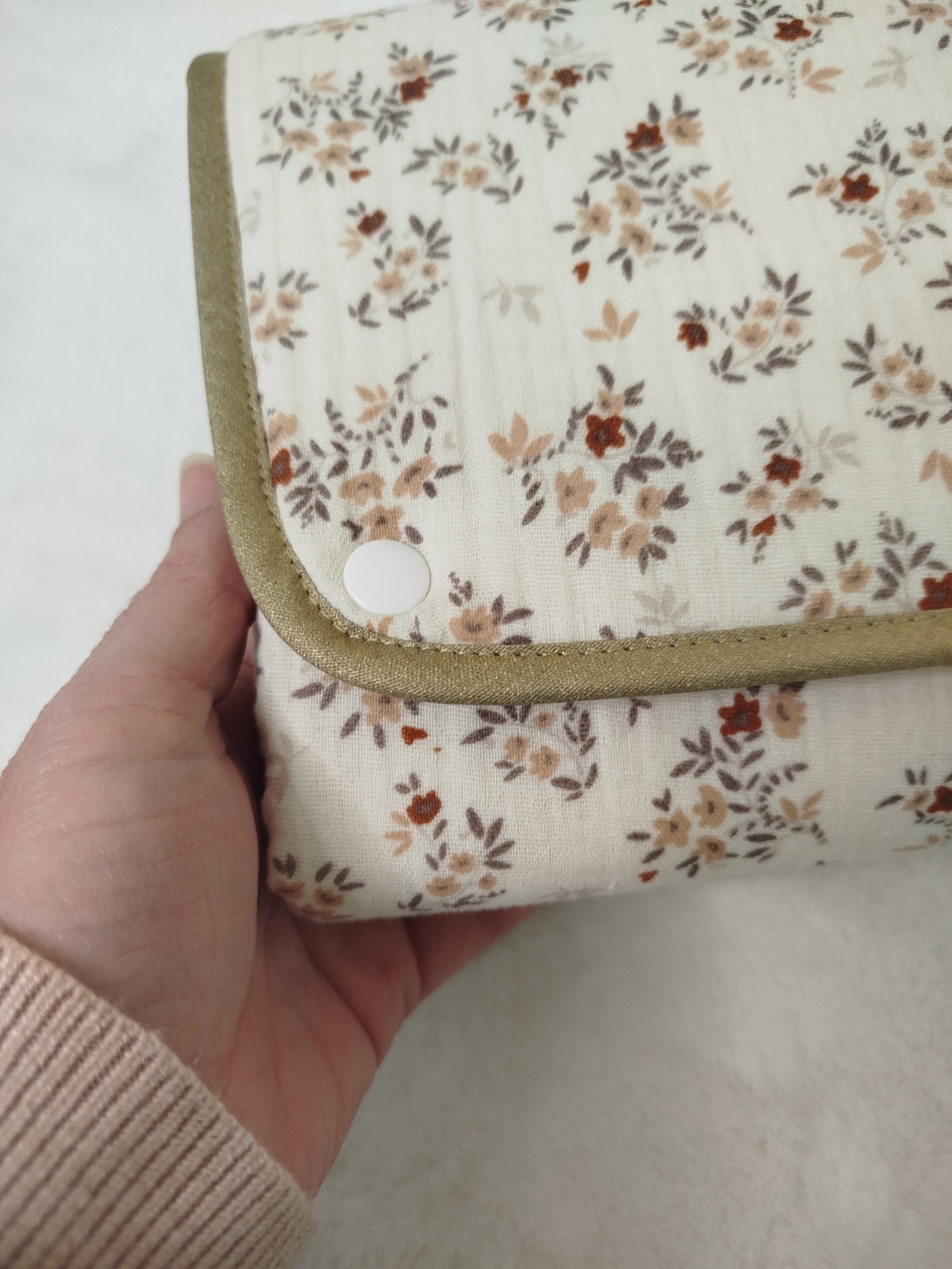 Muda fraldas portátil e impermeável | flores de outono | musselina e detalhes dourados Carteira ou bolsa dobrável em tecido floral com bordo verde e botão branco