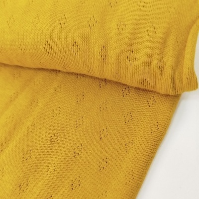 Tecido amarelo de malha com padrão de losangos