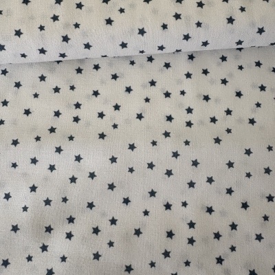 Tecido branco com estrelas pretas pequenas e padrão uniforme.