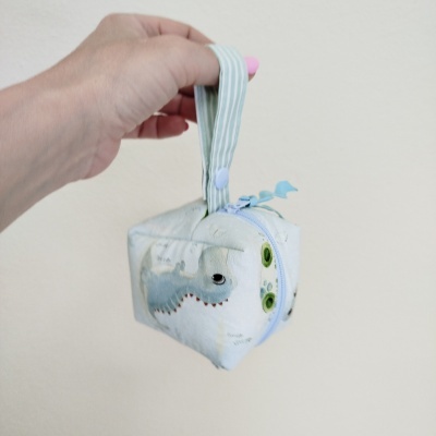 Bolsa pequena em tecido com padrão colorido e fecho de correr azul