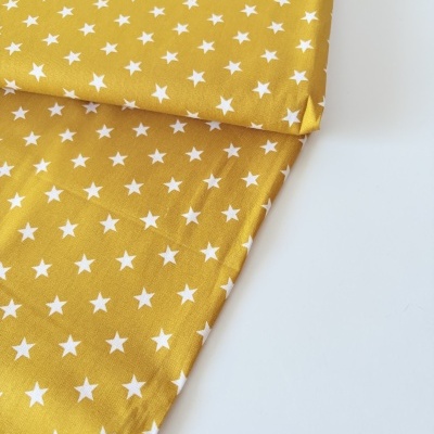 tecido amarelo com estrelas brancas pequeno padrão