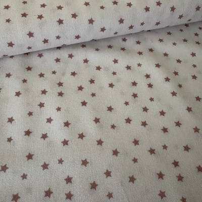 Tecido branco com estrelas castanhas pequenas