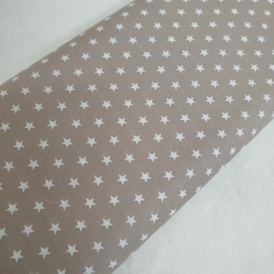 Tecido bege com estrelas brancas