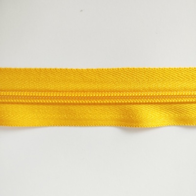 Fecho éclair amarelo em tecido com textura de nylon