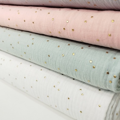 Tecidos coloridos com pontos dourados