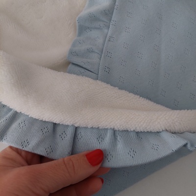 Pano azul claro de malha e tecido branco felpudo