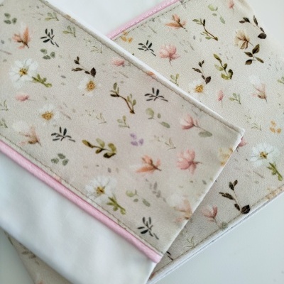 Toalhas brancas com padrão floral em tecido bege e borda rosa