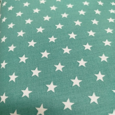 Tecido azul turquesa com estrelas brancas em padrão repetido