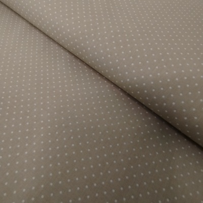 Tecido bege com padrão de pontos brancos pequenos