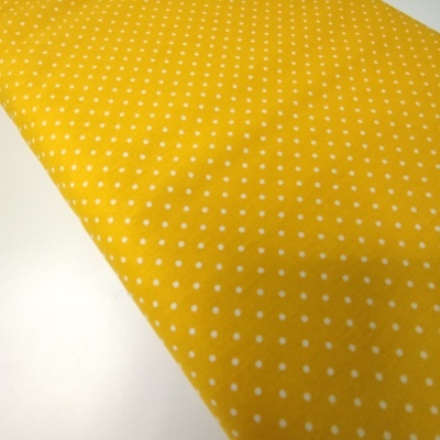 Tecido amarelo com pequenos pontos brancos