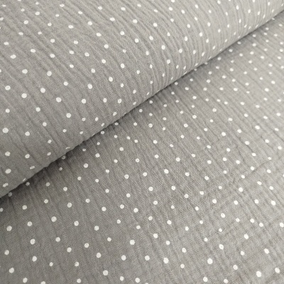 Tecido cinzento com pontos brancos e textura enrugada