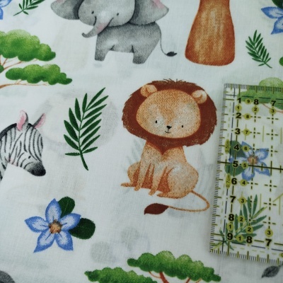 Tecido com estampado de animais e plantas com régua ao lado