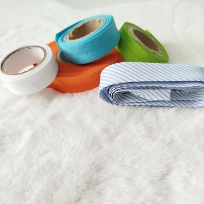 Rolos de fita têxtil colorida sobre pelúcia branca