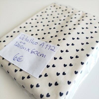 Retalho de tecido branco com mini corações pretos embalado com etiqueta manuscrita