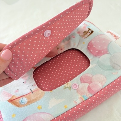 Estojo tecido para lenços com padrão de pontos brancos em fundo rosa e estampado colorido