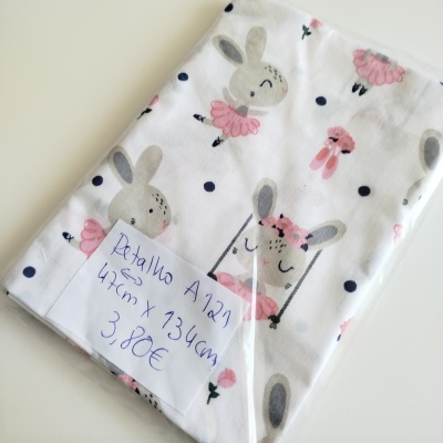 Pano branco com padrão de coelhos e etiqueta manuscrita com medidas e preço