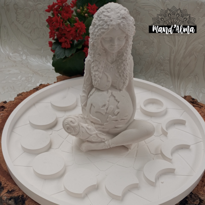 Estatua branca de mulher grávida segurando planeta Terra rodeada por fases da lua em base redonda branca.