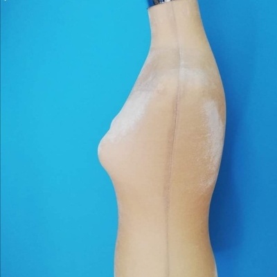 Manequim de costura feminino bege sobre fundo azul