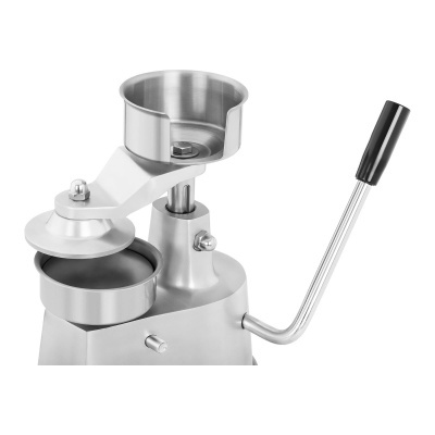 Máquina de prensar hambúrgueres em metal prateado com alavanca preta