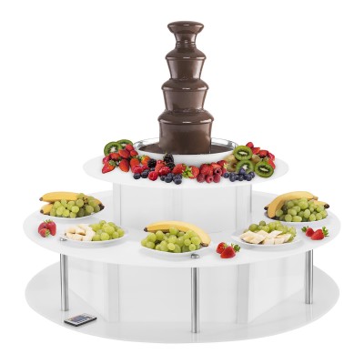 Fonte de chocolate com frutas frescas variadas numa base branca com várias tigelas