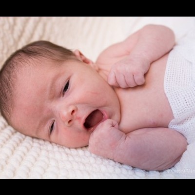 bebé recém-nascido deitado numa manta branca