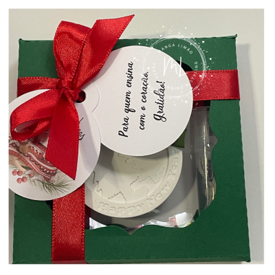 Caixa de presente verde com laço vermelho e etiquetas com texto e imagem de Natal