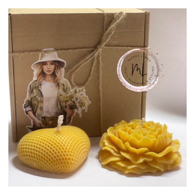 Caixa de cartão com velas amarelas em formato de maçã e flor e recorte de papel de mulher