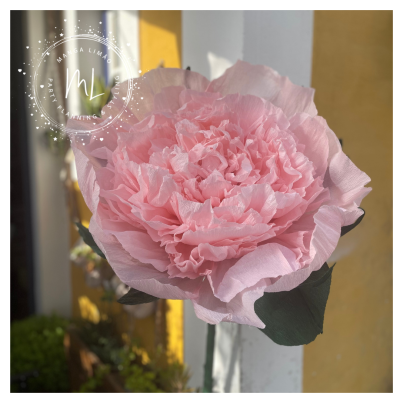 Flor decorativa rosa de papel com folhas verdes em fundo amarelo e branco