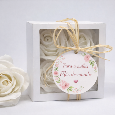 Caixa branca com quatro rosas artificiais e tag com mensagem para mãe
