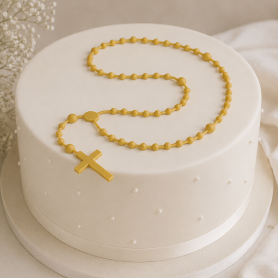 Bolo redondo branco com decoração de pérolas e terço amarelo por cima