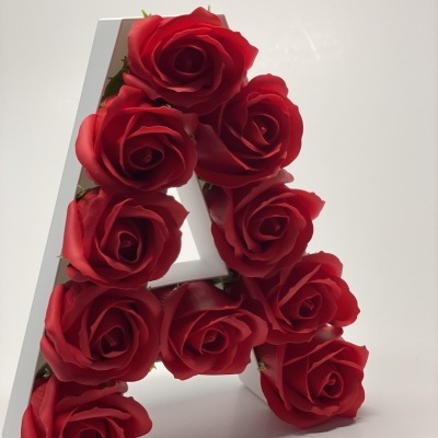 Letra A branca com rosas artificiais vermelhas