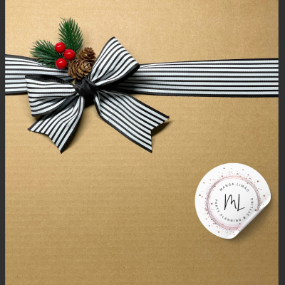 Caixa de cartão castanho com laço preto e branco e decoração de pinhas e bagas vermelhas