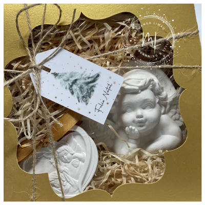 Conjunto de esculturas de anjos brancos em caixa dourada com etiqueta de Feliz Natal