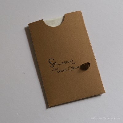 Pacote retangular em cartão castanho com texto em português e detalhe de corações