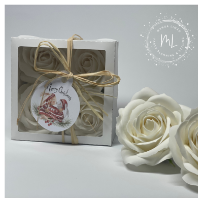 Caixa com flores artificiais brancas em forma de rosa com etiqueta Merry Christmas