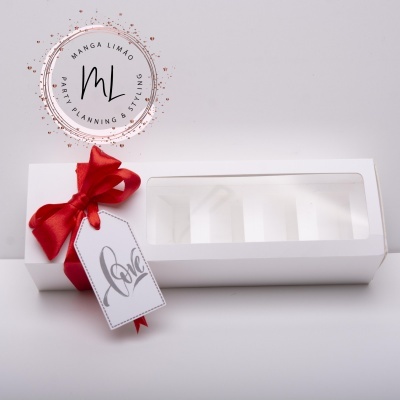 Caixa branca com tampa transparente, fita vermelha e etiqueta 'LOVE'
