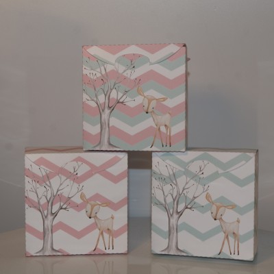 Três quadros decorativos com padrão zig-zag e ilustração de árvore e veado em tons pastéis.